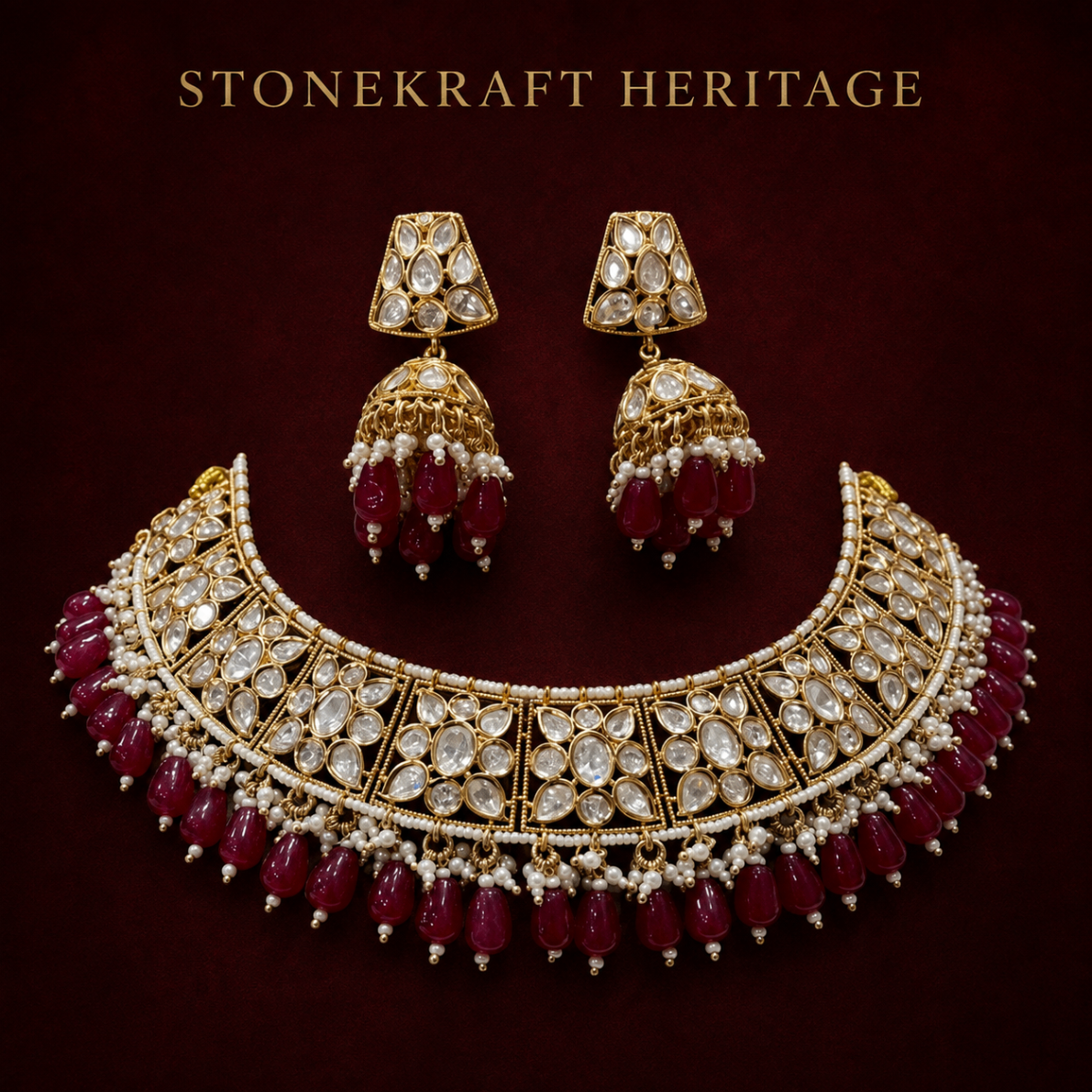 Temple-style kundan choker with ruby drops and jhumka earrings on burgundy
